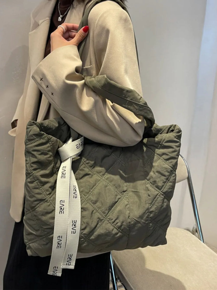 Diamond quilt nylon tote bag in moss with white logo strap