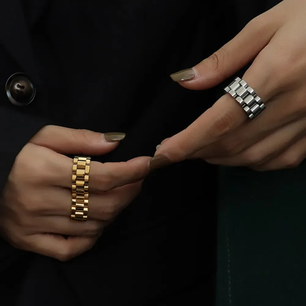 Watch link statement ring in gold and silver, featuring a bold, segmented design.