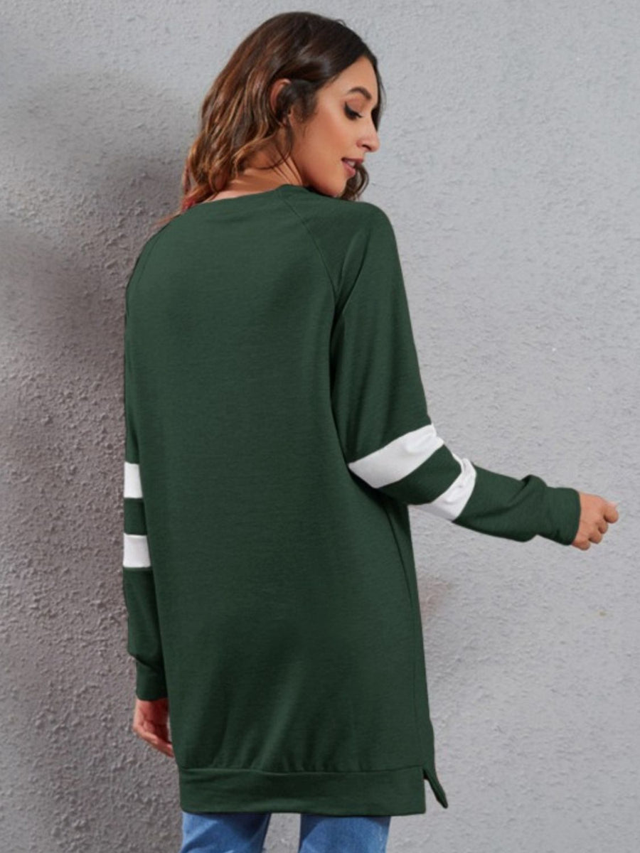 Dark Green sweatshirt dress with white varsity stripes on the sleeves.
