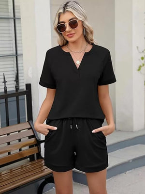 Black two-piece set with V-neck top and drawstring shorts with pockets