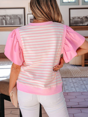 Pink and white striped blouse with ruffled short sleeves and crew neck.