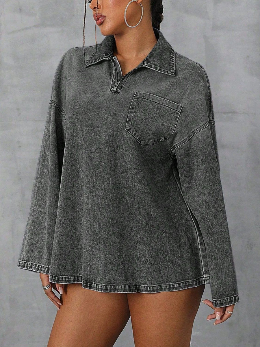 Oversized dark denim polo shirt with a quarter zip, collared neckline, and chest pocket.