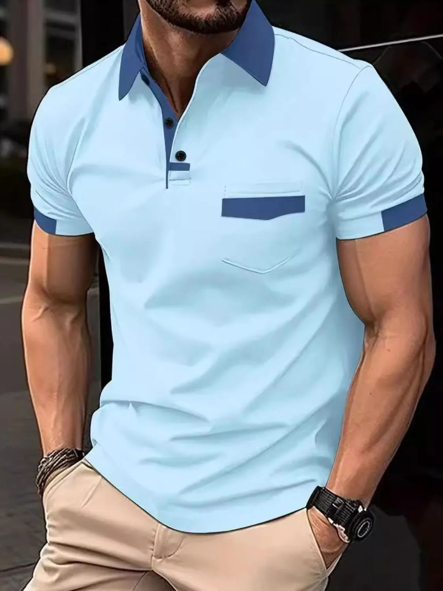 Color-blocked polo shirt in mint blue with navy accents on collar, pocket, and sleeves.
