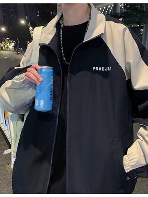 Black and beige zip-up jacket with a stand-up collar and text