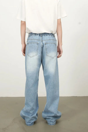 Baggy denim palazzo jeans in medium wash with elastic waistband and whiskering details.