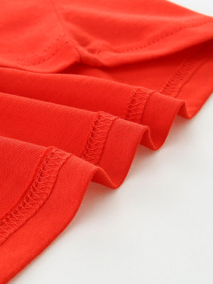 Children's red t-shirt detail showing hem and stitching
