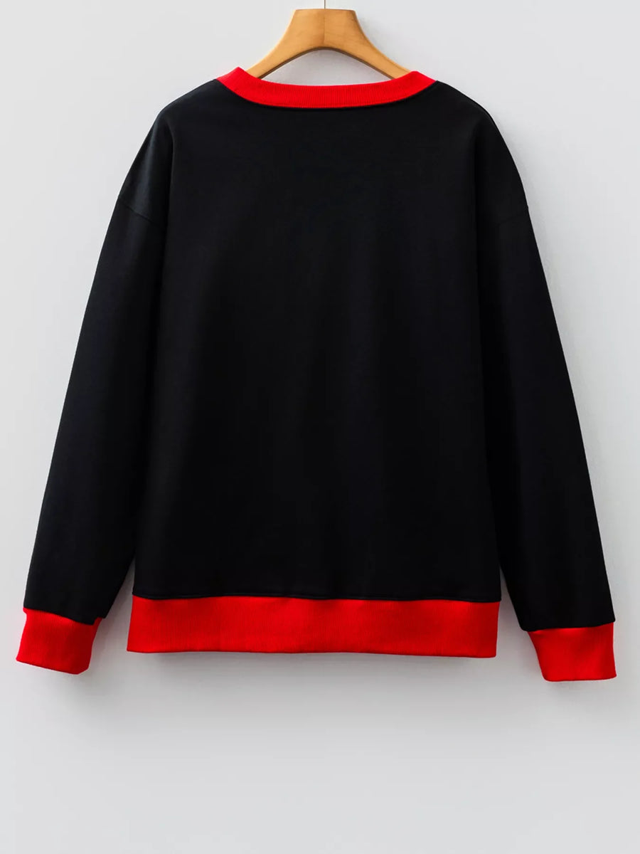 Black sweatshirt with red collar and cuffs, comfortable casual wear.