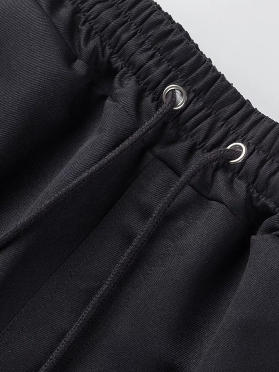 Black cargo shorts with adjustable drawstring waist and metal grommets.