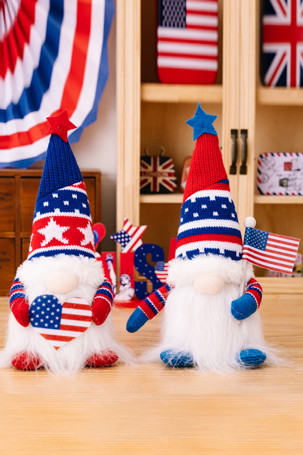 Patriotic gnomes in red, white, and blue with star patterns, one holding a heart, the other a flag.
