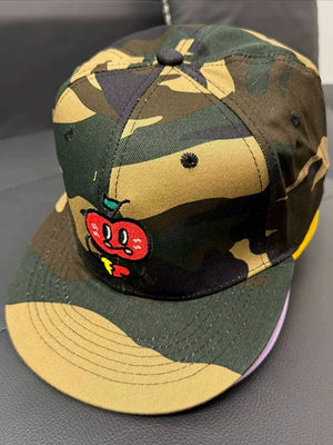Camouflage baseball cap with a red apple embroidery and yellow brim detail.