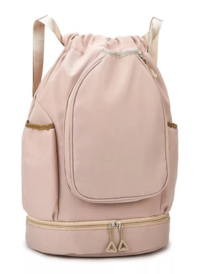 Blush pink drawstring duffle bag with front pocket and zippered bottom compartment.