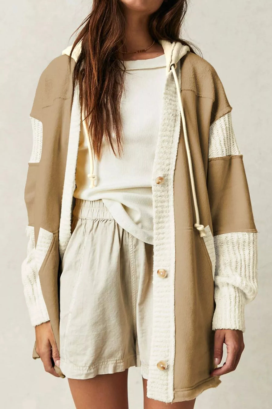 Knit trim drawstring hoodie in camel with contrast panels and button front, worn over a white tee and shorts.