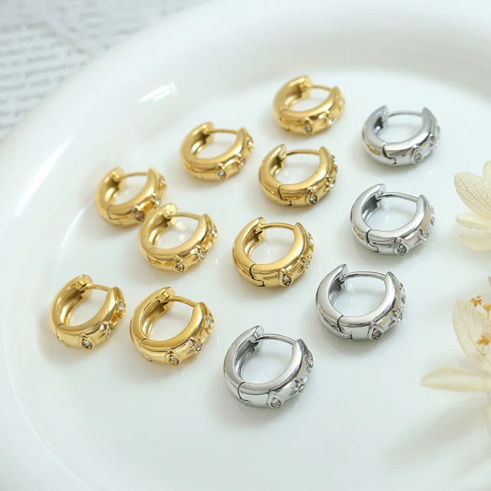 Gold and silver zirconia-embellished mini huggie hoop earrings with a casual style.