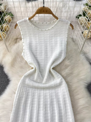 White knit midi dress with pearl neckline detail and cutout pattern.