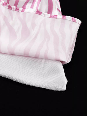 Pink and white zebra print top with striped trim and white mesh hem.