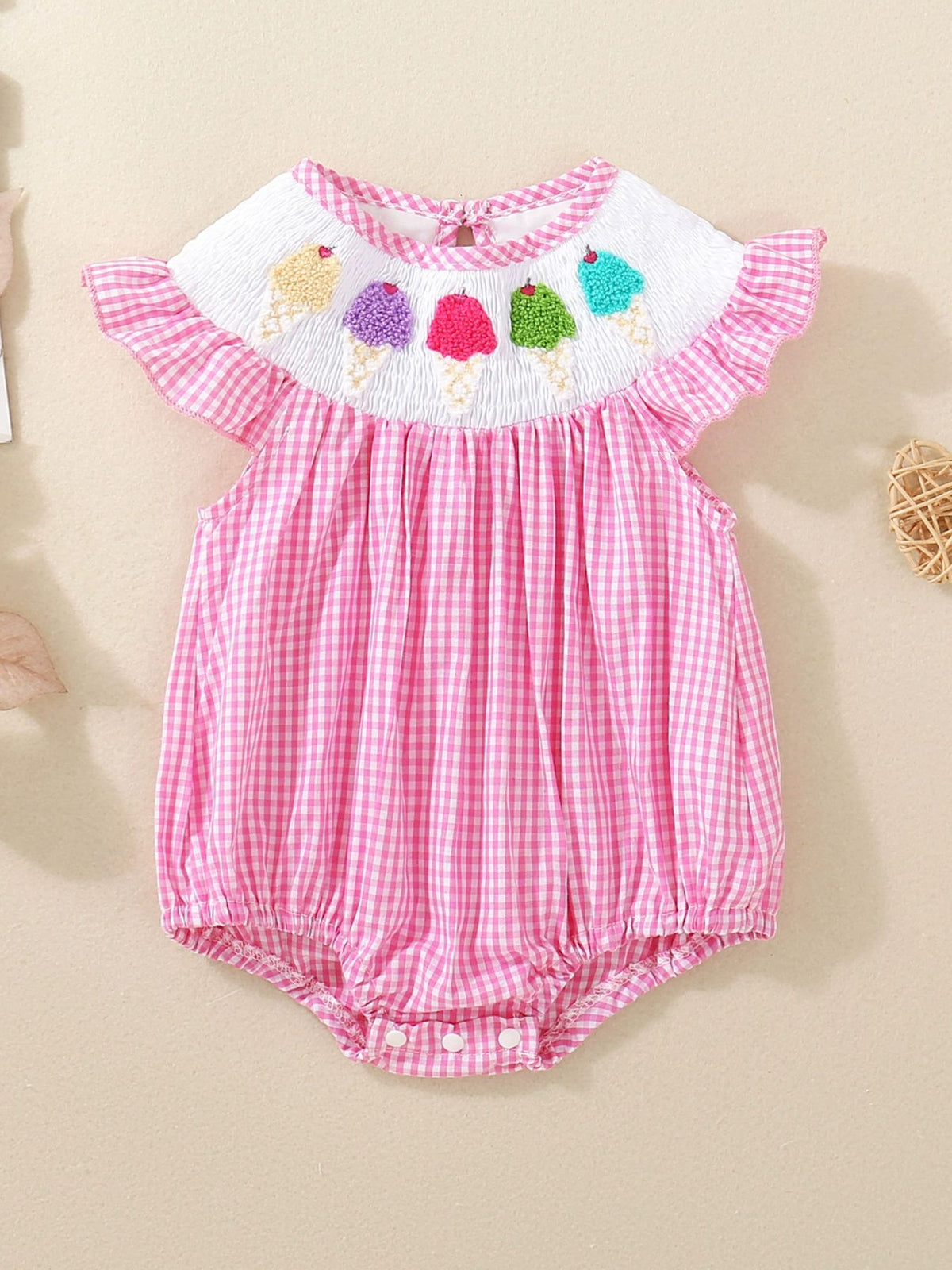 Pink gingham baby bubble romper with smocked white bib featuring embroidered ice cream cones.