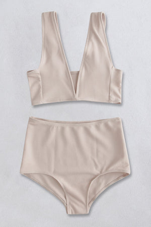 Ribbed cream high-waist plunge bikini set with a deep V-neckline and high-cut bottoms.