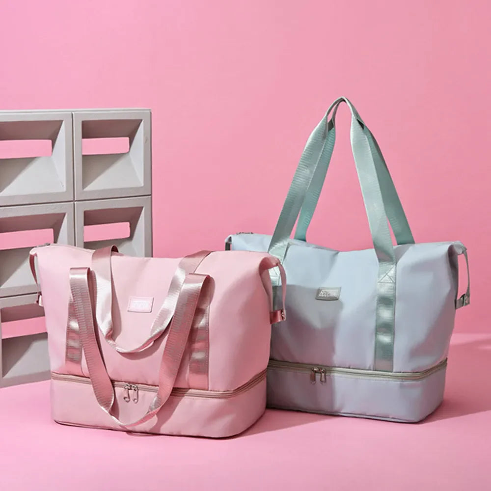 Pink and dusty blue dual-compartment travel totes with metallic trim and dual zippers.