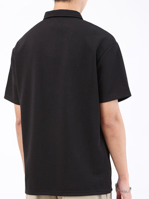 Black textured performance polo shirt for men, short sleeves, classic collar.