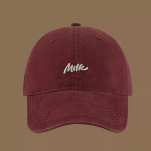 Wine red baseball cap with embroidered "Milk" text detail