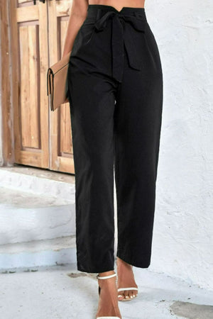 Belted high-waist palazzo trousers in black with a cinched bow detail.