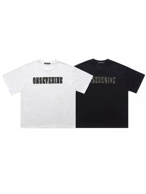 Oversized cotton t-shirts in black and white, each with a bold graphic logo print.