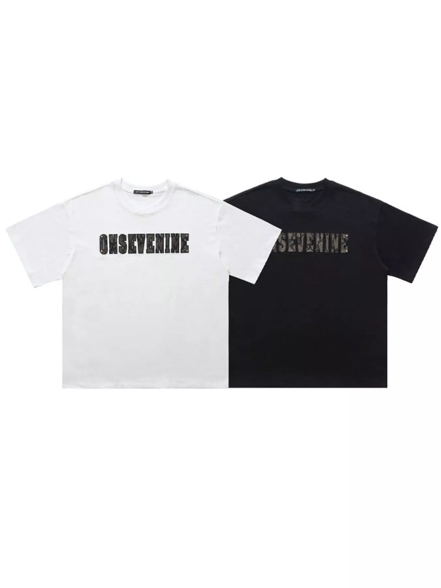 Oversized cotton t-shirts in black and white, each with a bold graphic logo print.