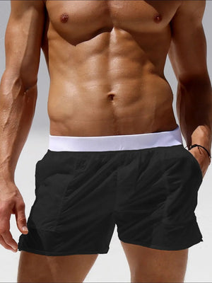 Black sheer swim shorts with white waistband and pocket detail.