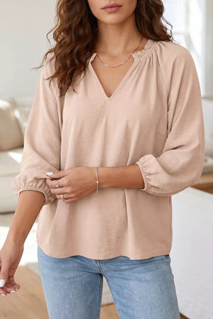 Blush pink textured v-neck peasant blouse with gathered neckline and balloon sleeves
