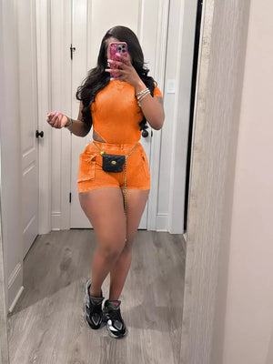 Orange ribbed crop top and pocket shorts set with a chain belt
