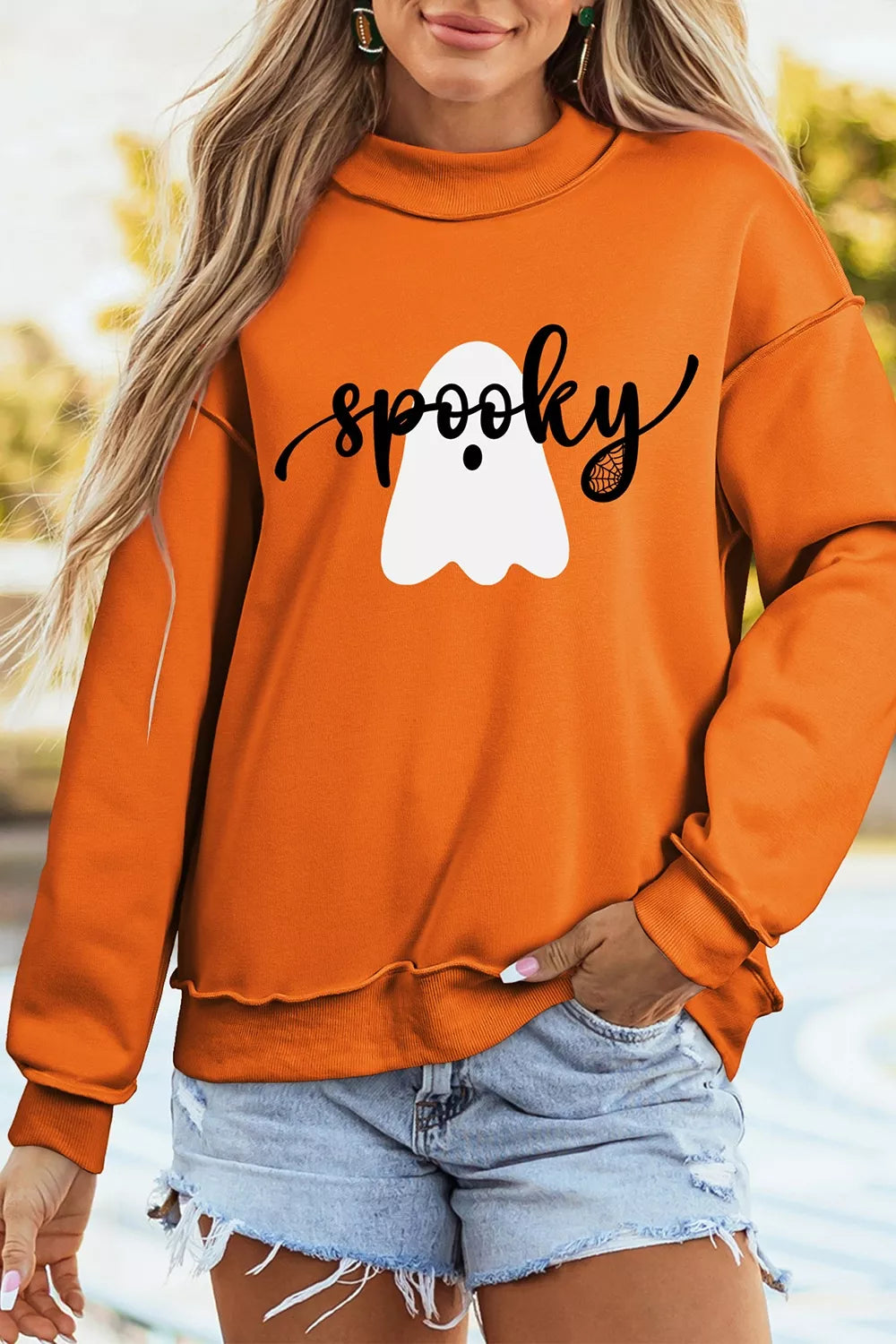 65% polyester, 35% cotton Care instructions: Machine wash cold sweatshirt in orange with relaxed silhouette