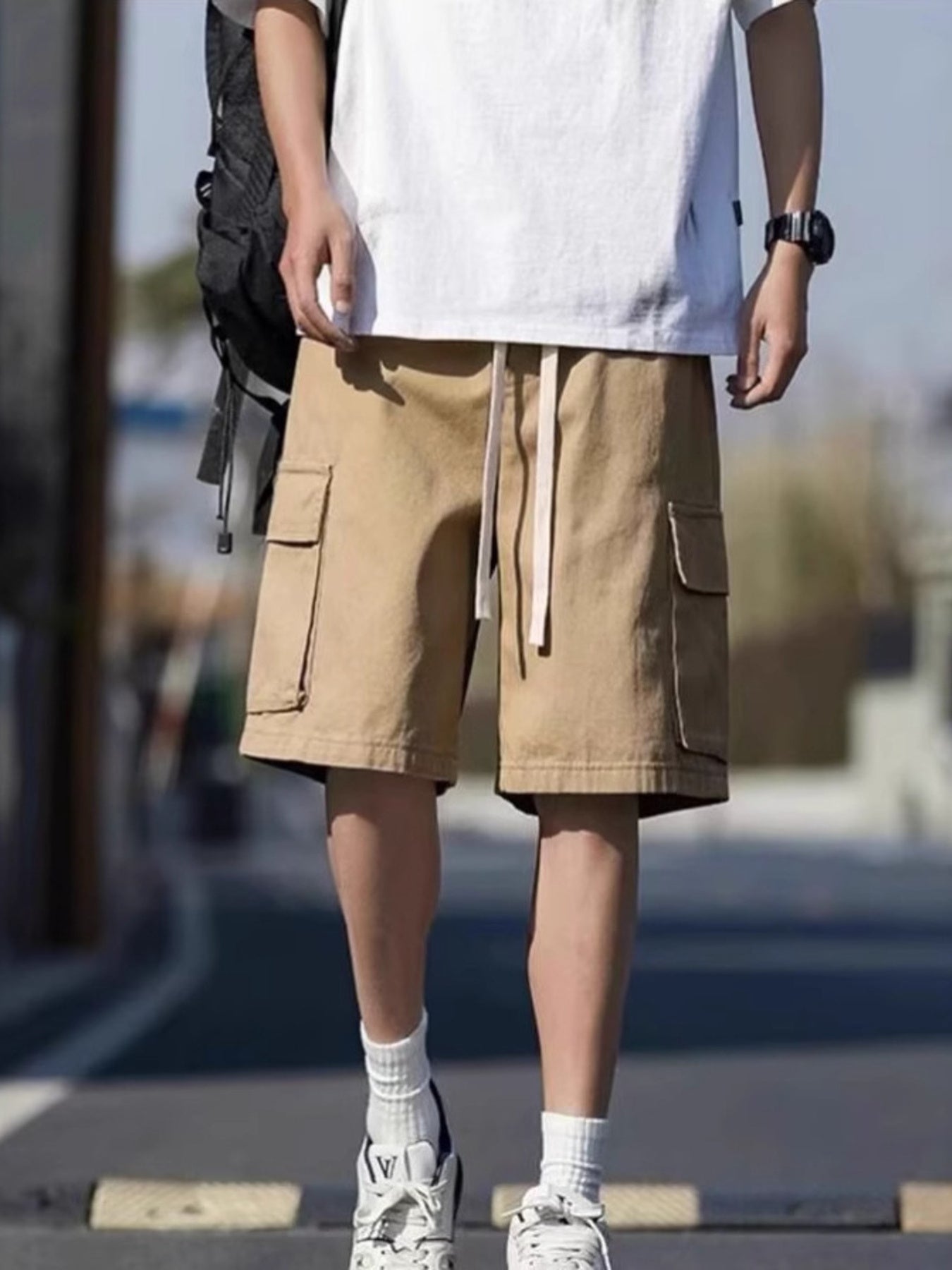 Men's tan casual cargo shorts with drawstring waist and side pockets.