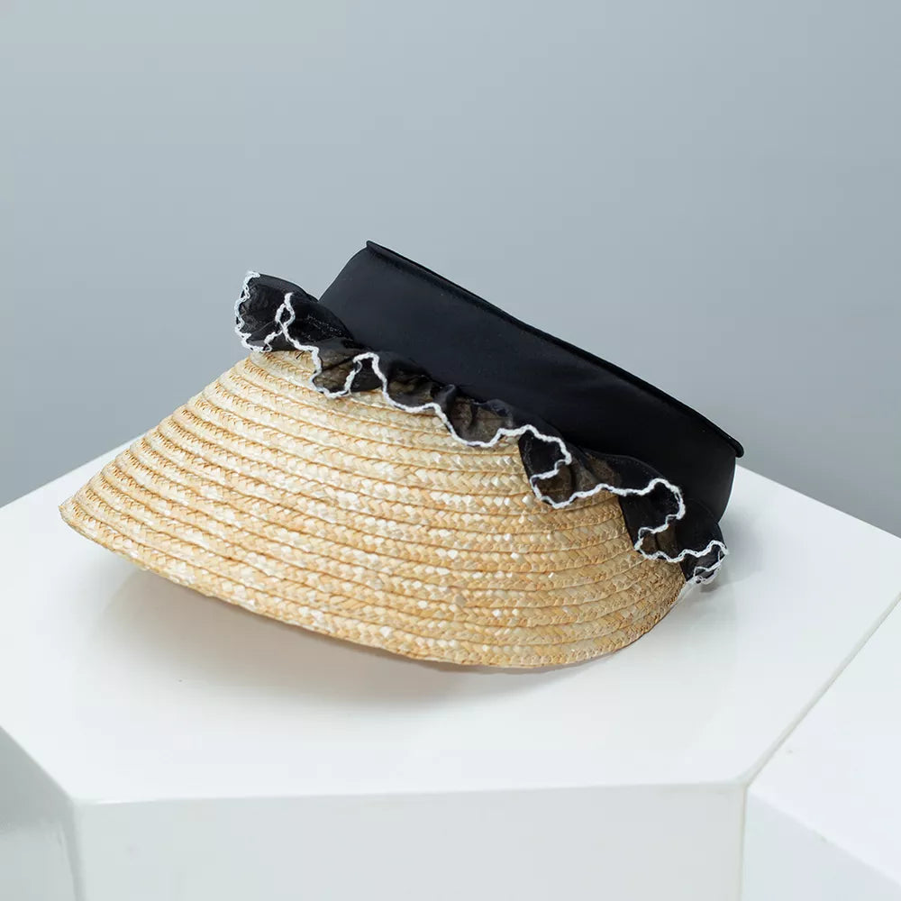 Straw visor hat with black band and white lace trim