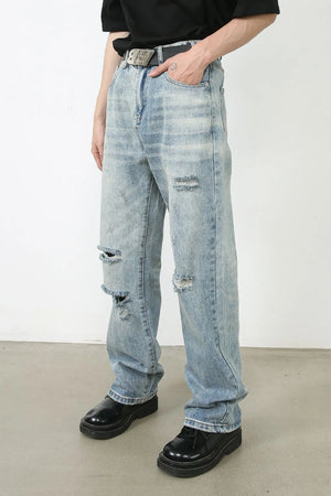 Baggy light wash denim jeans with distressed rips and a modern fit.