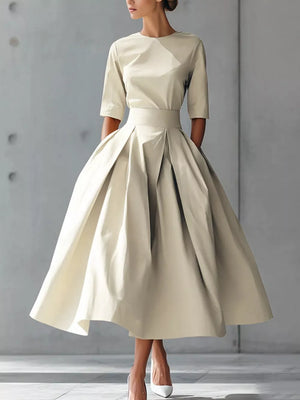 Camel A-line midi dress with a pleated skirt and short sleeves.