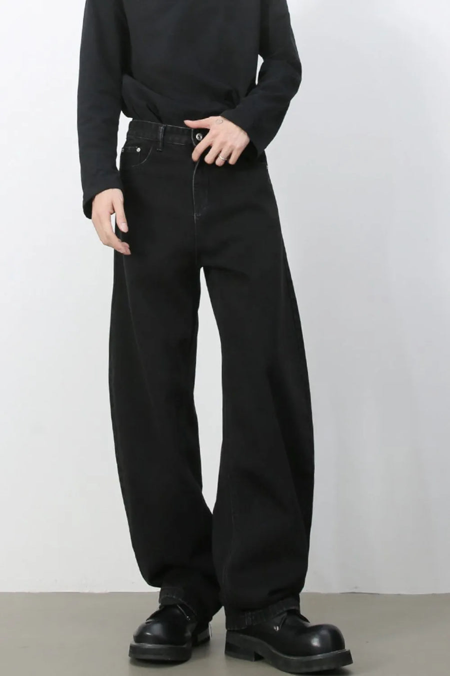 Black denim balloon trousers with a high waist and wide leg.