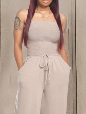 Strapless smocked taupe jumpsuit with wide legs and drawstring waist