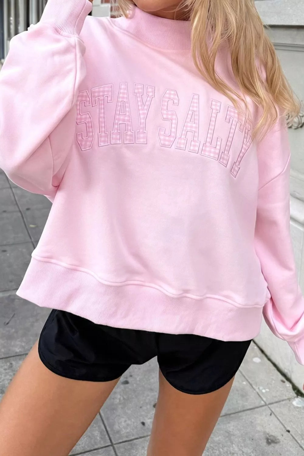 65% polyester, 35% cotton Care instructions: Machine wash cold sweatshirt in light pink with relaxed silhouette