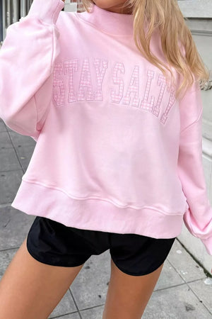 65% polyester, 35% cotton Care instructions: Machine wash cold sweatshirt in light pink with relaxed silhouette