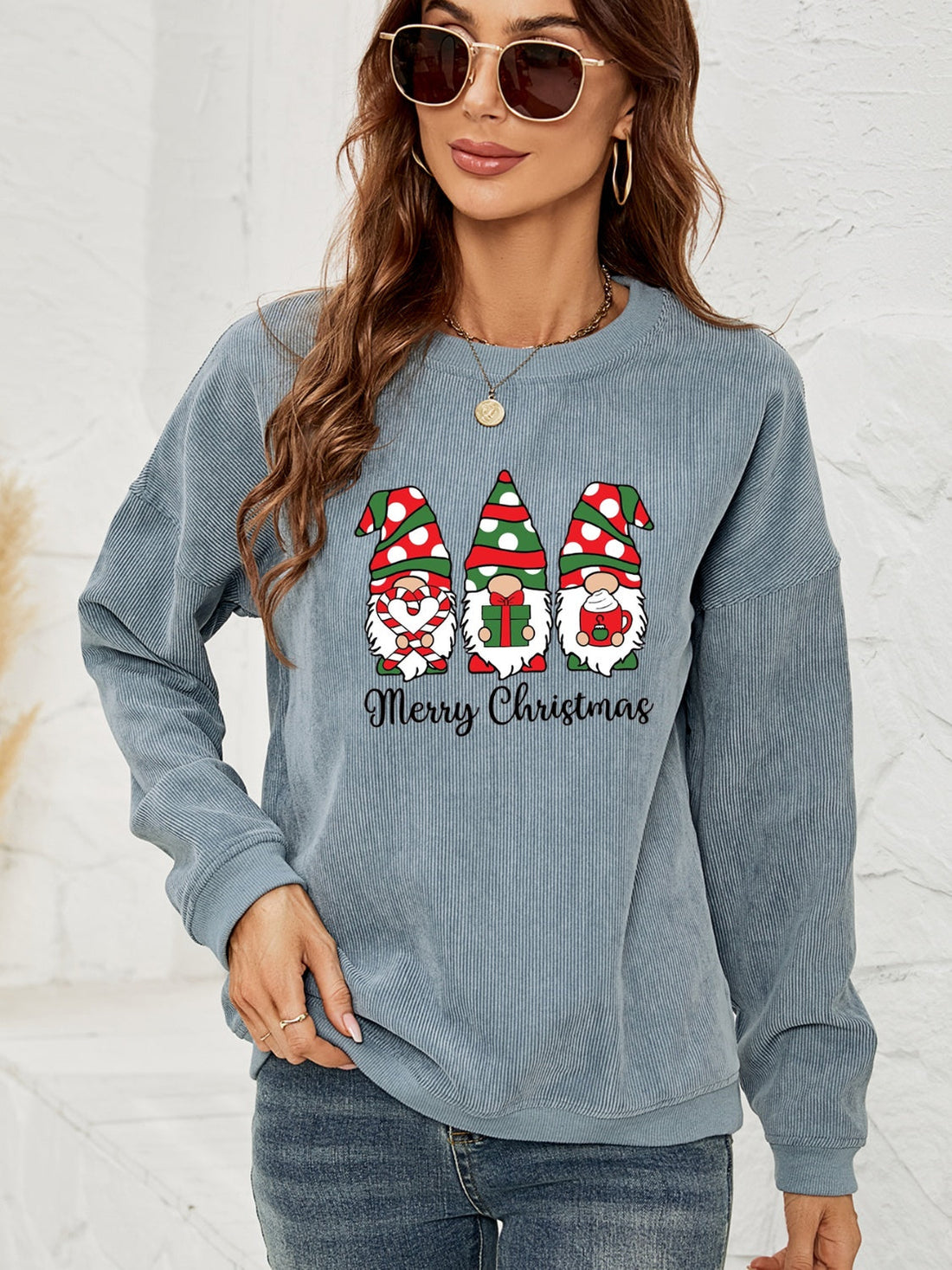 Light blue corduroy sweatshirt with three Christmas gnomes and Merry Christmas graphic.