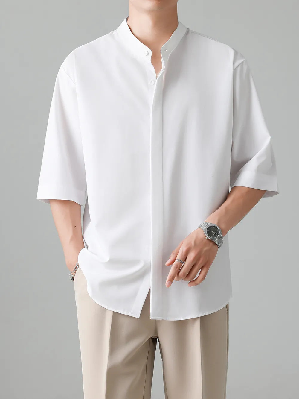 White oversized mandarin collar half-sleeve shirt with button-down front.