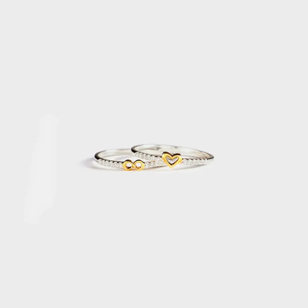 Silver rings with gold heart and infinity symbols, set with small stones