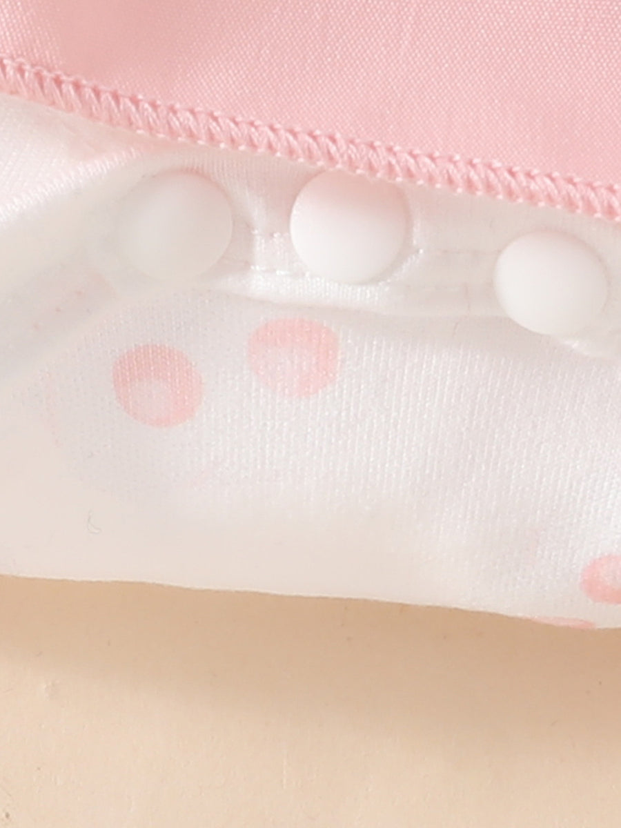 Pink baby dress with white polka dots and snap closures