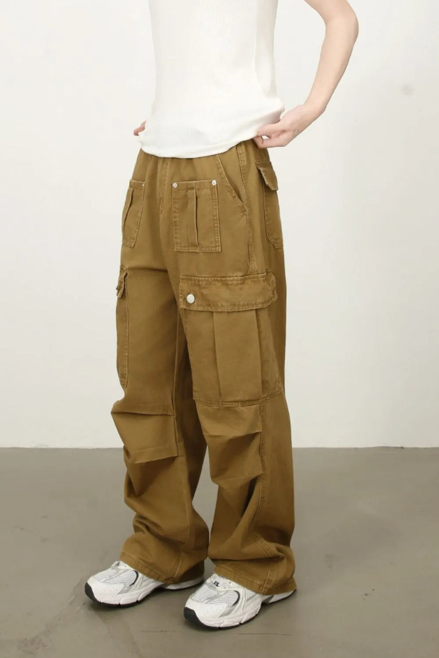 Khaki cargo pants with multiple pockets and a wide-leg cut.