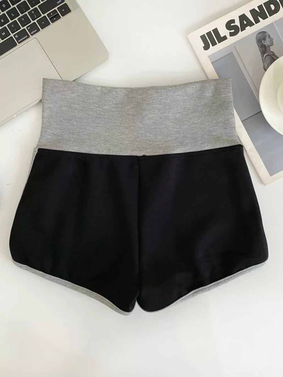 Black jogger shorts with gray high-rise waistband and contrast trim.