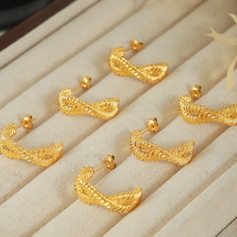 Gold vermeil braided hoop stud earrings with a twisted design.