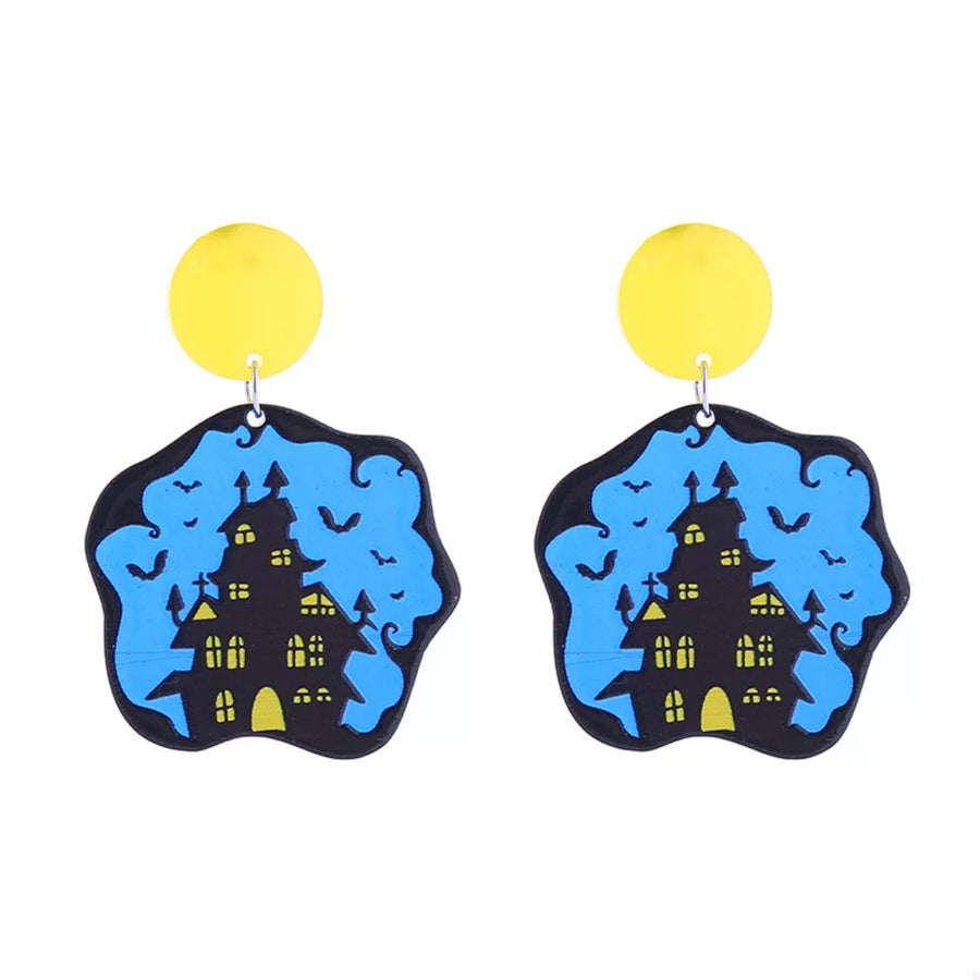 Spooky dangle earrings with haunted house and bats on blue background, yellow top.