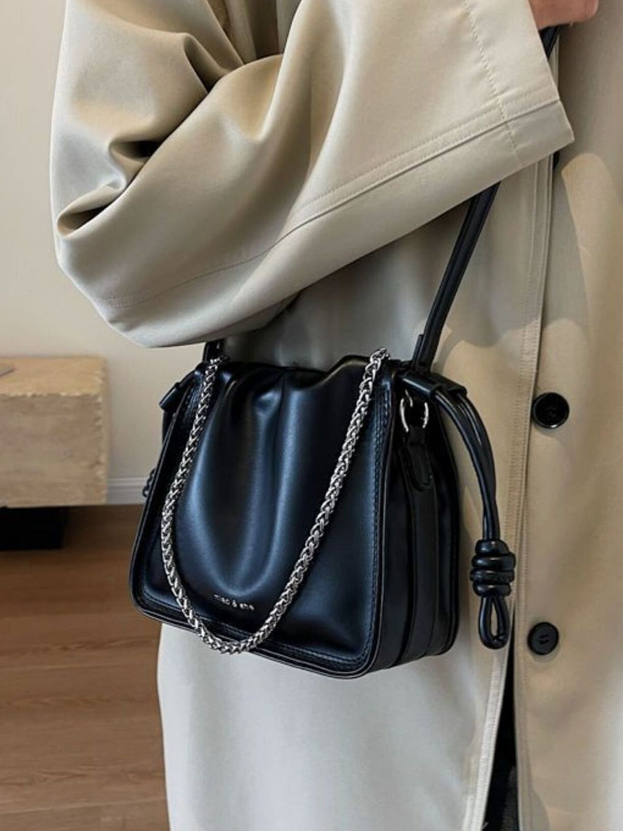 Black ruched PU leather crossbody bag with silver chain strap and knot detail