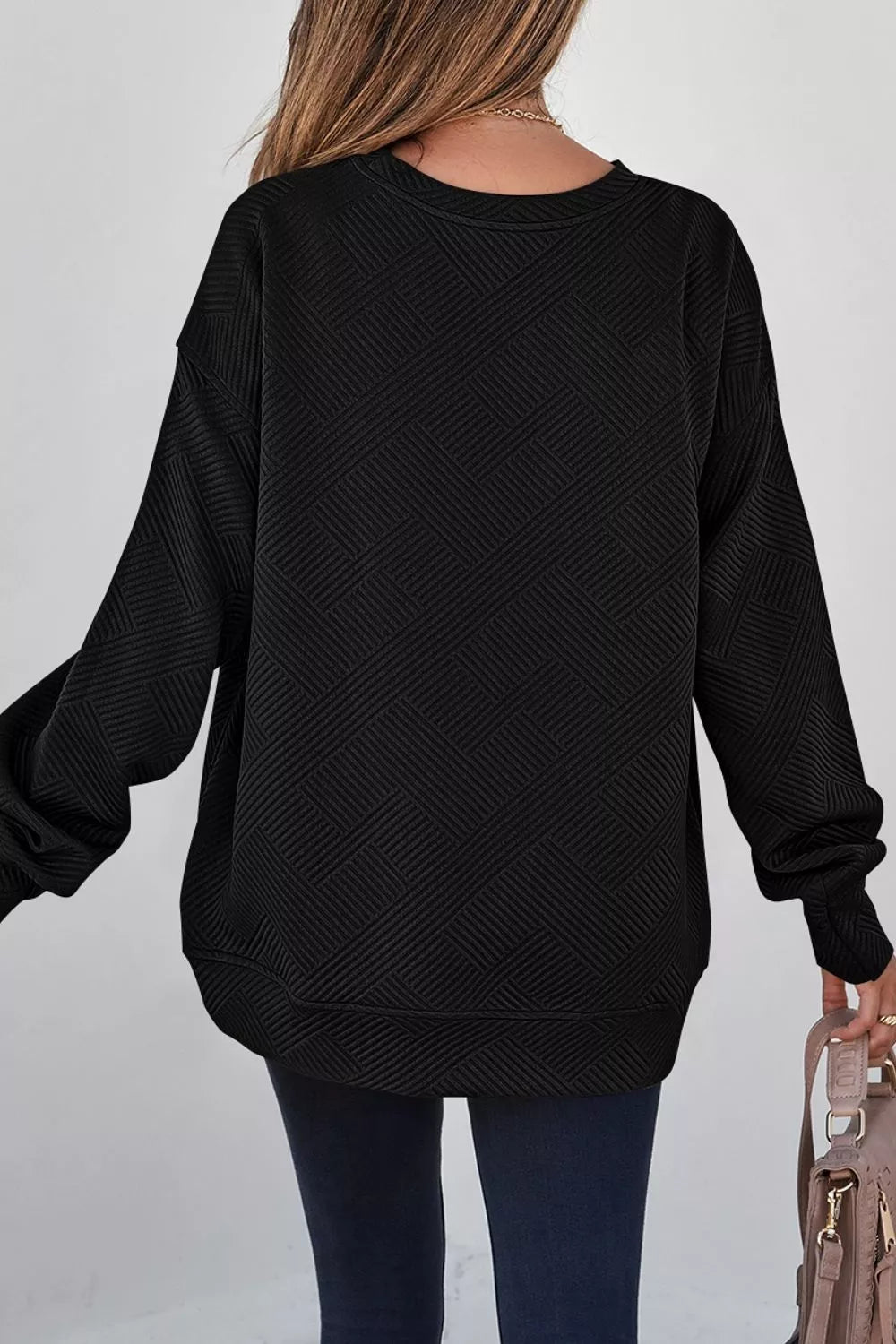 Black sweatshirt featuring drop shoulder and geometric