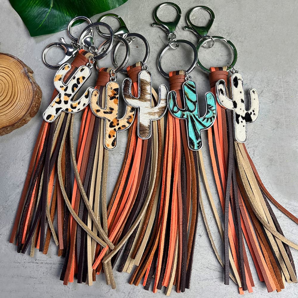 Cactus leather keychains with multi-color tassels in animal print, cowhide, and turquoise styles.